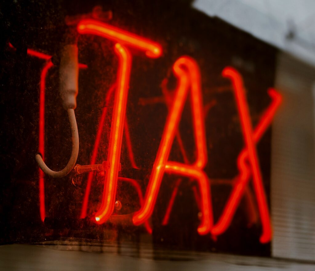 neon sign saying "TAX"