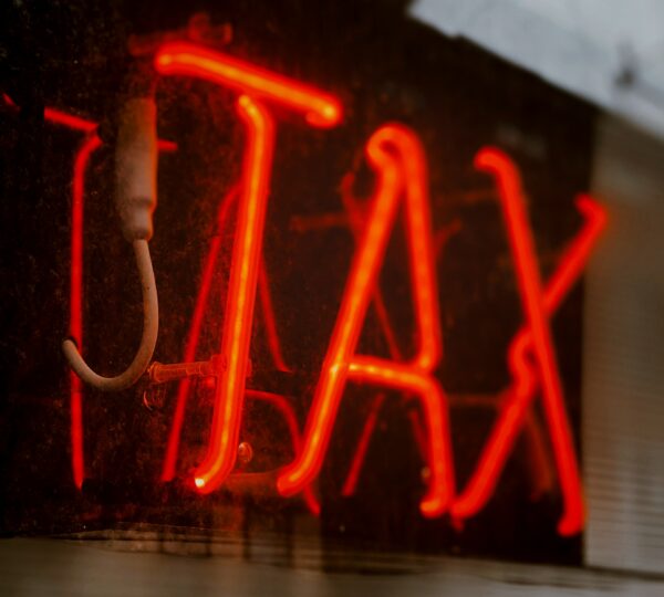 neon sign saying "TAX"